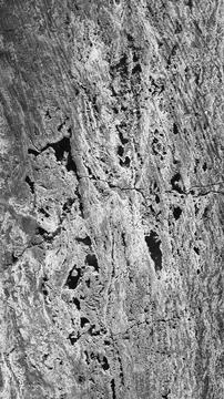 Texture of a rough, porous surface, showcasing intricate patterns of wear o.. Stock Photos
