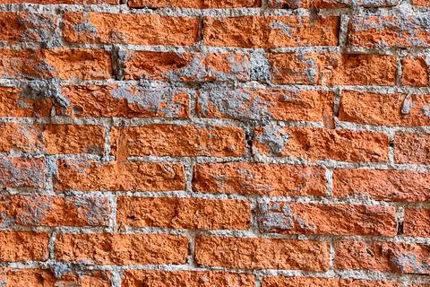 Texture rough red brick wall closeup Stock Photos