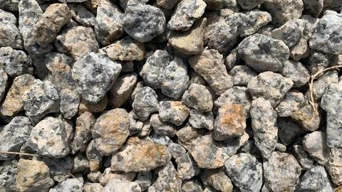 Texture of rough rock wall. Rough rocks are randomly placed Stock Photos