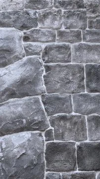 Texture of rough stone surface showcases architectural design, emphasizing Stock Photos