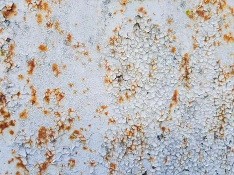 Texture of rusting metal covered with peeling white paint. Stock Photos