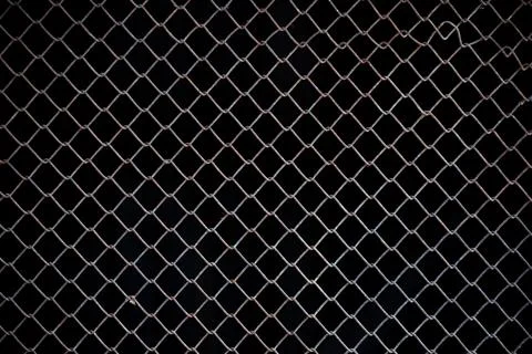Texture of rusty iron mesh, on a black background Stock Photos