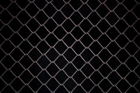 Texture of rusty iron mesh, on a black background Foto stock