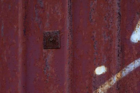 Texture of rusty metal surface with a patch. An old rusty sheet of iron with  스톡 사진