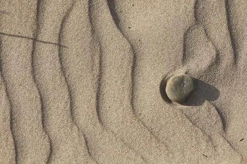  Texture of sand leveled by the wind with some pebbles Texture of sand lev... Stock Photos