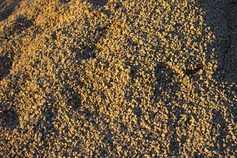 Texture of sand in light. Small material. Granules in sunlight. Stock Photos