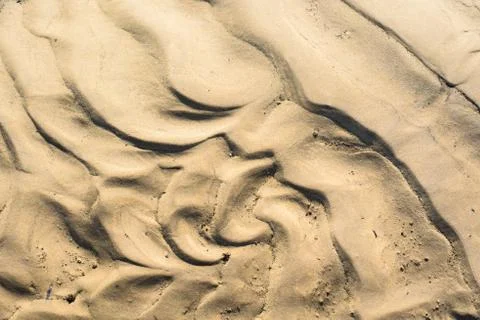 The texture of the sand is yellow. close up. background image Stock Photos