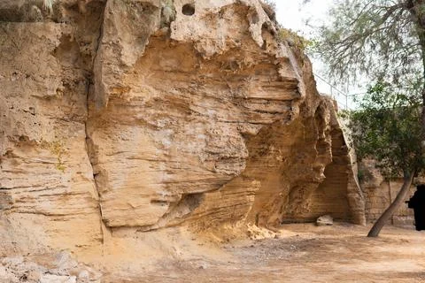 Texture of sandstone in a cave in the rays of the sun. Stock Photos