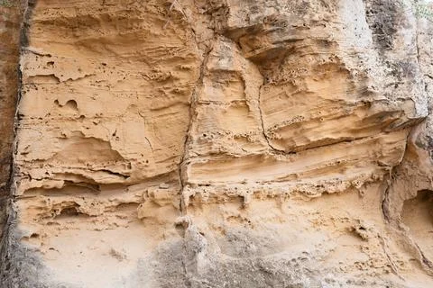 Texture of sandstone in a cave in the rays of the sun. Stock Photos
