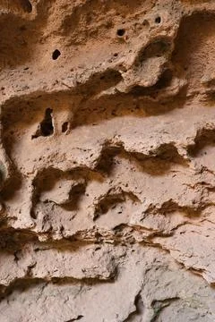 Texture of sandstone in a cave in the rays of the sun. Stock Photos