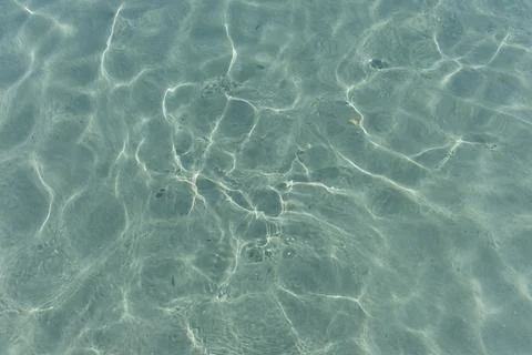 Texture of the sea water surface with small waves and sun reflections. Stock Photos