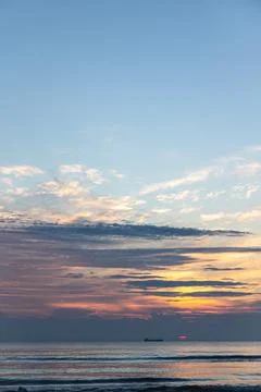 Texture sea waves at sunset with pink clouds. Stock Photos
