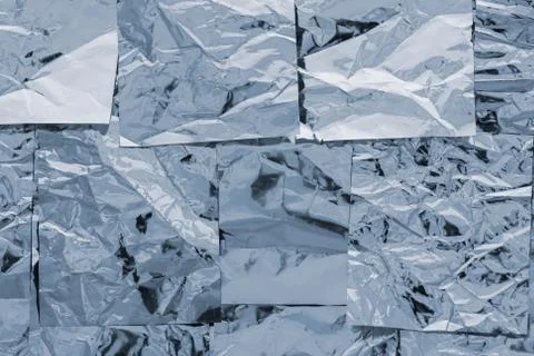 A texture of several layers of shiny silver foil. Vertical background in wint Stock Photos