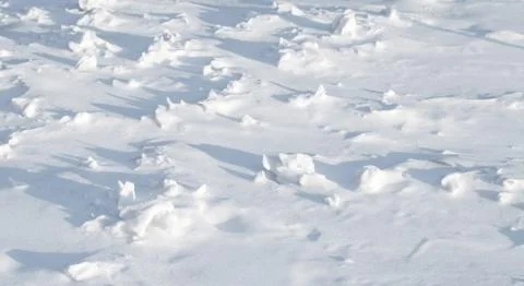 Texture of sharp hilly snowdrift with nice shadows Stock Photos