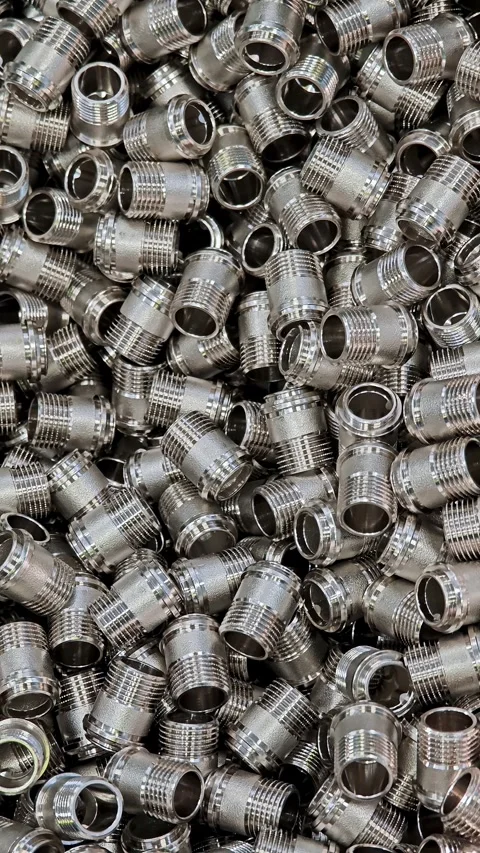 Texture of shiny steel hex nuts in an industrial container. Abstract pattern of Stock Footage 329325754