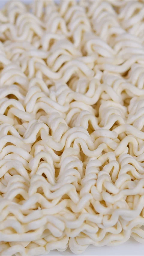 Texture shot showing wavy dry noodles on white background. Detailed photograph c Stock Footage 333891258