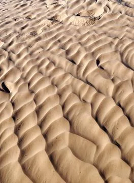 Texture Shot of Wind Swept Sand Ripples and Footprints in Desert Dunes Stock Photos