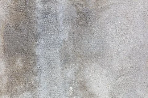 Texture shows rough concrete surface with faded gray and brown patches Stock Photos
