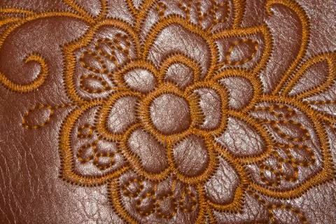 The texture of the skin with embroidered patterns Stock Photos