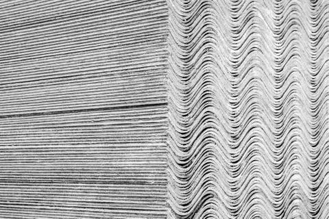 Texture. Slate sheets lie on top of each other and form a straight and undula Stock Photos
