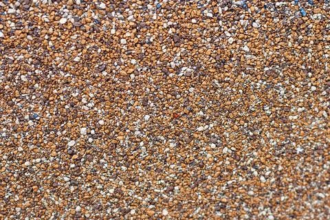 Texture of small brown pebbles of different shades Stock Photos