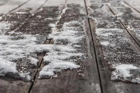 A texture of a small snowdrift of white snow with ice and with bokeh light on Stock Photos