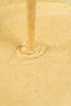 Texture of smooth creamy batter flowing down. Stock Photos