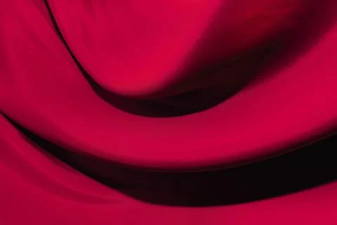 The texture of a smooth elegant fabric of silk, satin burgundy, red, magent.. Stock Photos