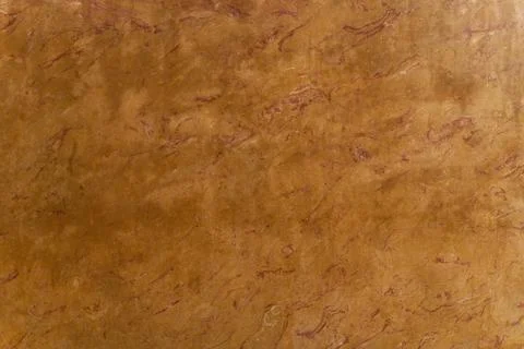 The texture of a smooth surface of a brown-red stone with a pattern. Stock Photos