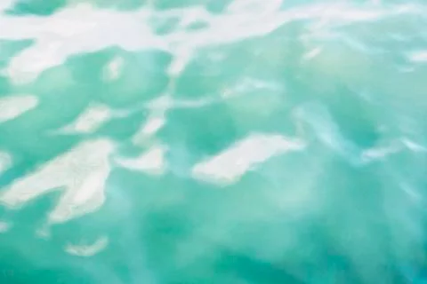 Texture of a smooth surface of water with patches of light and sunshine Stock Photos