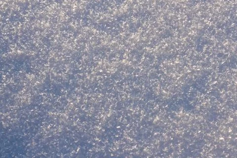 Texture of snow glitters in sun pattern. Christmas, new year, morning before Stock Photos