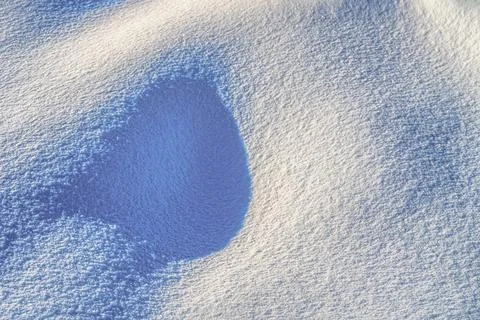 Texture of snow illuminated by sunlight. Stock Photos