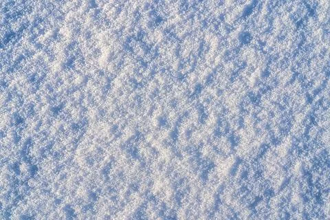 Texture of snow illuminated by sunlight. Stock Photos