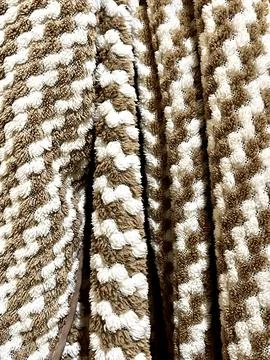 Texture of soft brown and white tufted fabric mat strands background pattern Stock Photos