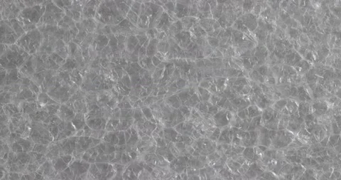 The texture of the soft film is close-up. Macro fragment of packaging material. 動画素材 165265724