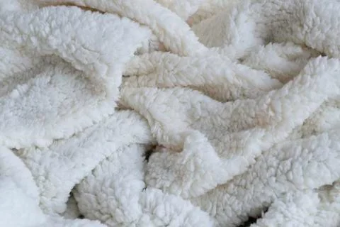 Texture of a soft plaid. Crumpled white warm blanket. Fabric crumpled in fold Stock Photos