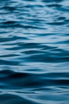 Texture of the soft waves of a calm blue sea Stock Photos