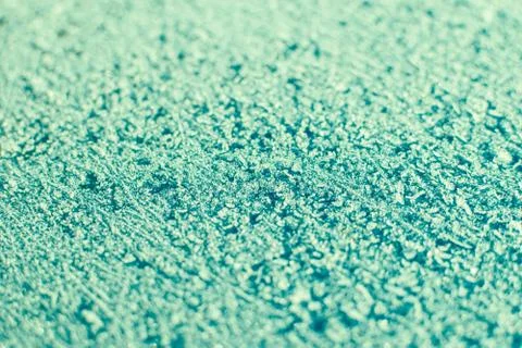 Texture of sparkling first cold ice. Snowy backdrop in green colors. Winter b Stock Photos