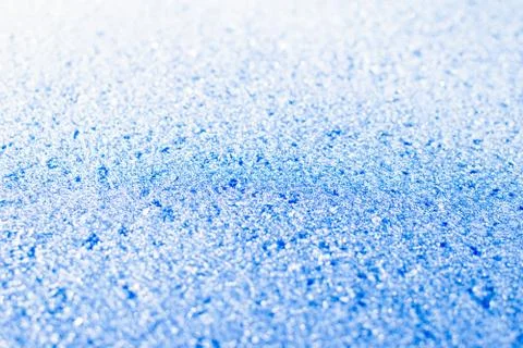 Texture of sparkling first cold ice. Blue snowy backdrop. Winter background f Stock Photos