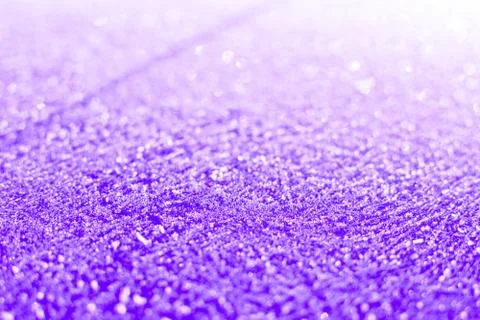 Texture of sparkling first cold ice. Snowy backdrop in purple colors. Winter Stock Photos