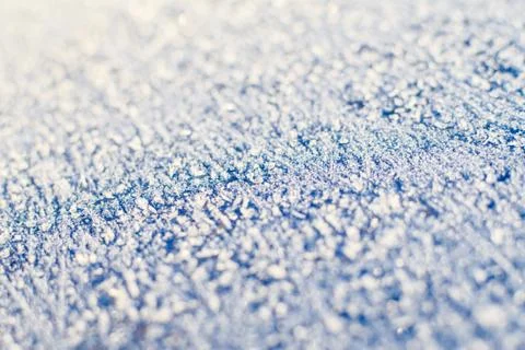 Texture of sparkling first cold ice. Blue snowy backdrop. Winter background f Stock Photos