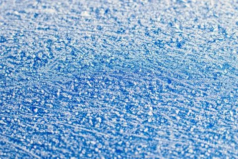 Texture of sparkling first cold ice. Blue snowy backdrop. Winter background f Stock Photos