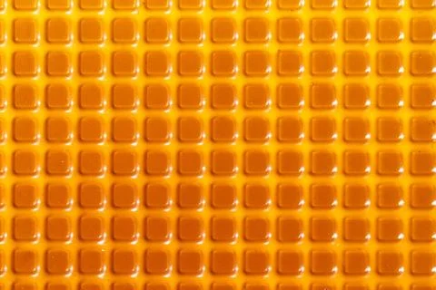 Texture with square yellow elements. Plastic candy lining Stock Photos