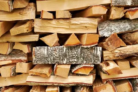 Texture of a stack of chopped and stacked firewood in a village Stock Photos