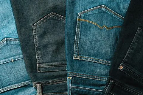Texture from a stack of jeans turned back pockets Stock Photos