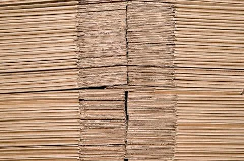 Texture of stacked on each other sheets of cardboard representing the unforme Stock Photos
