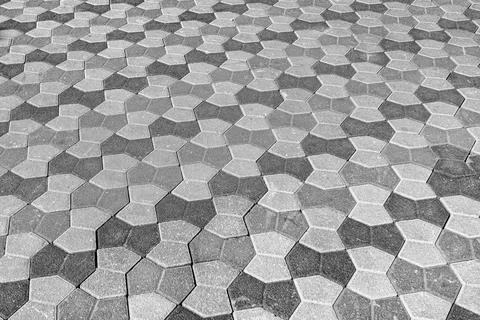 The texture of a stone old pavement with a perspective. Black and white. Stock Photos