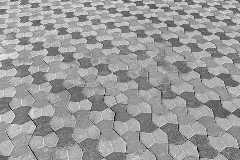 The texture of a stone old pavement with a perspective. Black and white. Stock Photos