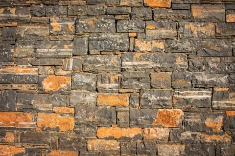 Texture of a stone. Old stone wall texture background. Grey stone wall as a b Stock Photos