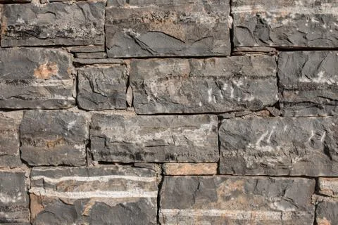 Texture of a stone. Old stone wall texture background. Grey stone wall as a b Stock Photos
